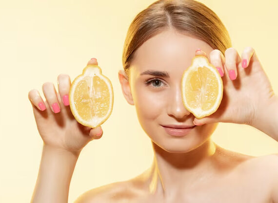 a beautiful young woman holding lemon slices