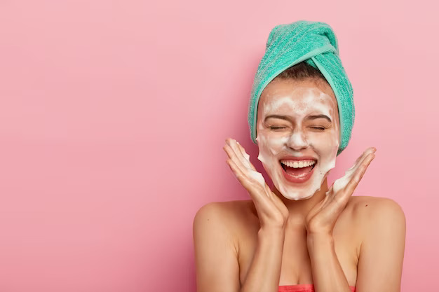 a woman is having fun double cleansing her face